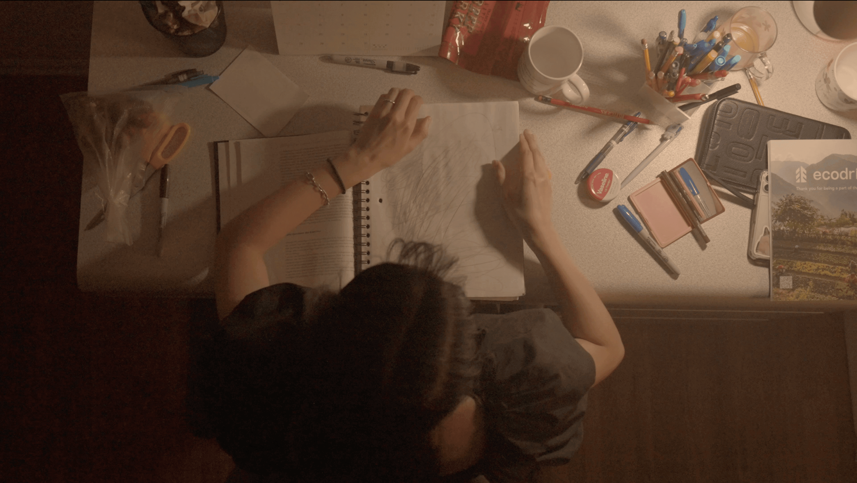 Main character grabbing her study notebook to close