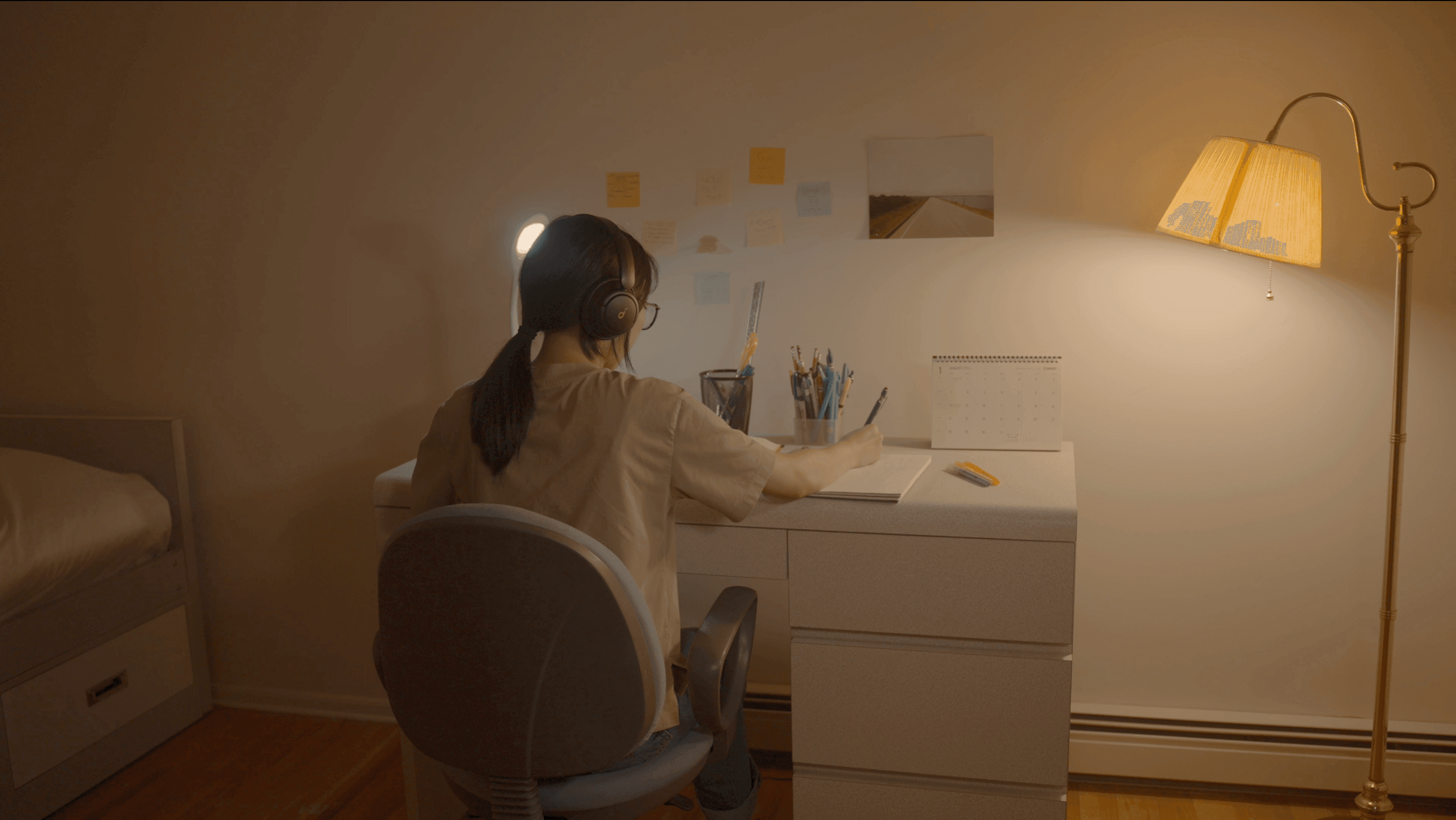 Main character studying at her desk