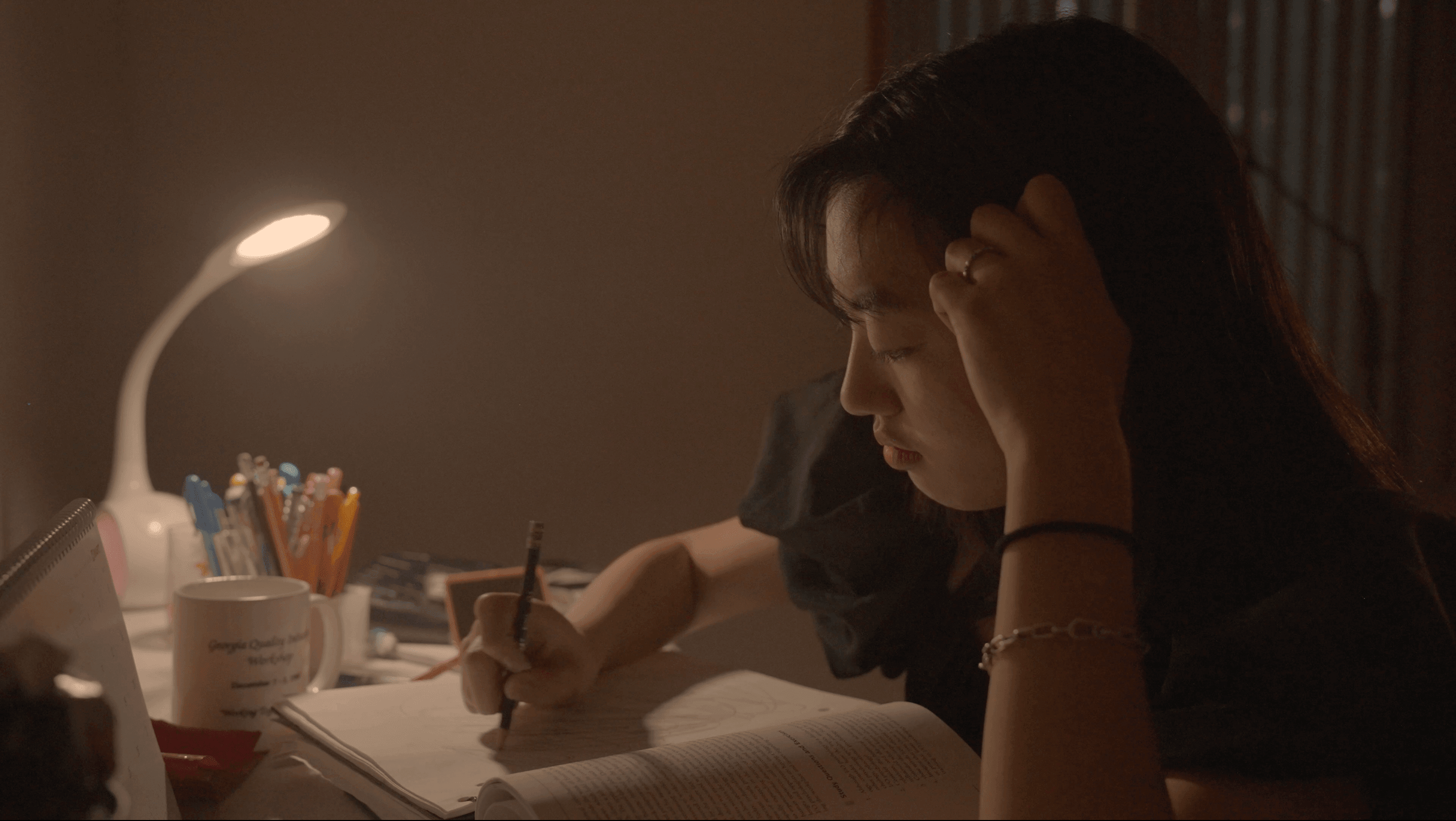 Main character looking at her textbook, but having difficulty focusing