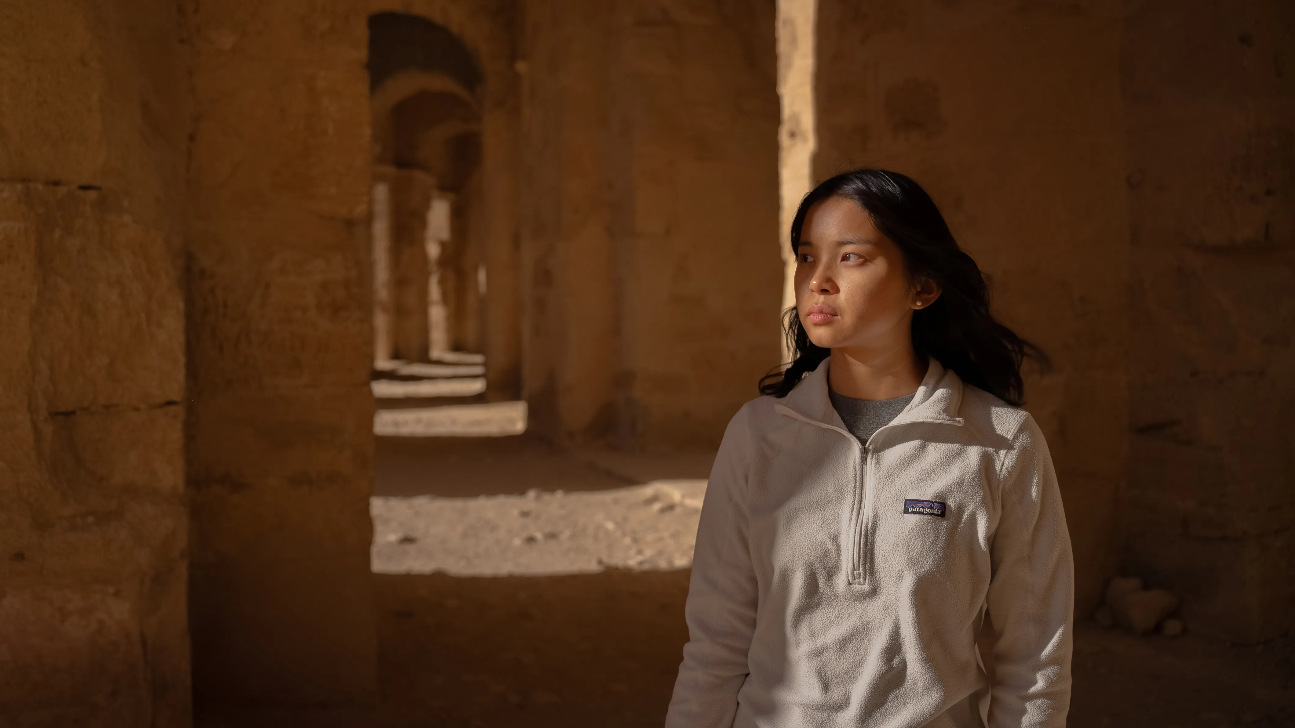girl inside the columns of The Amphitheatre of El Jem