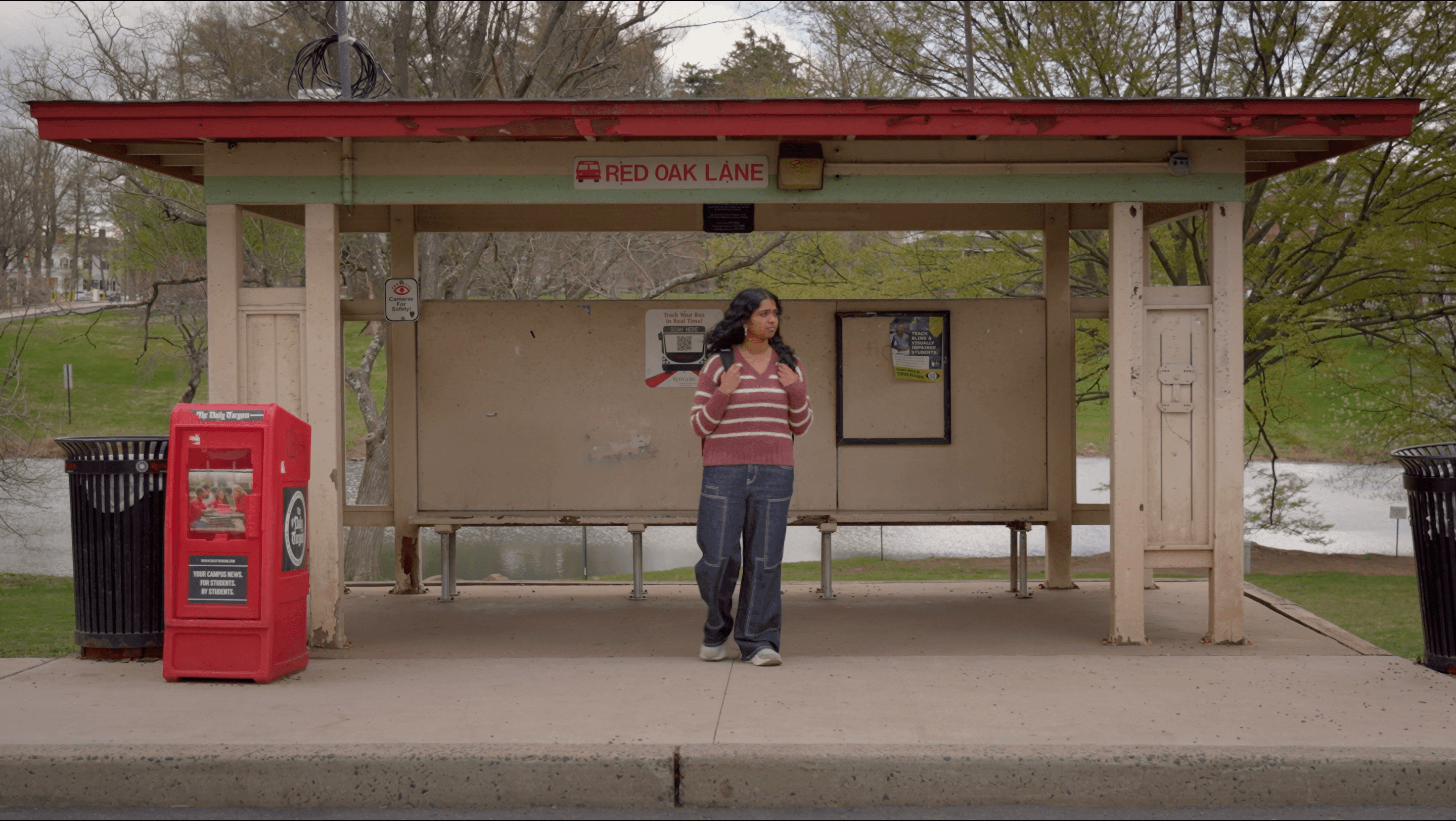 Main character waiting for her bus at the Cook Doug bus stop