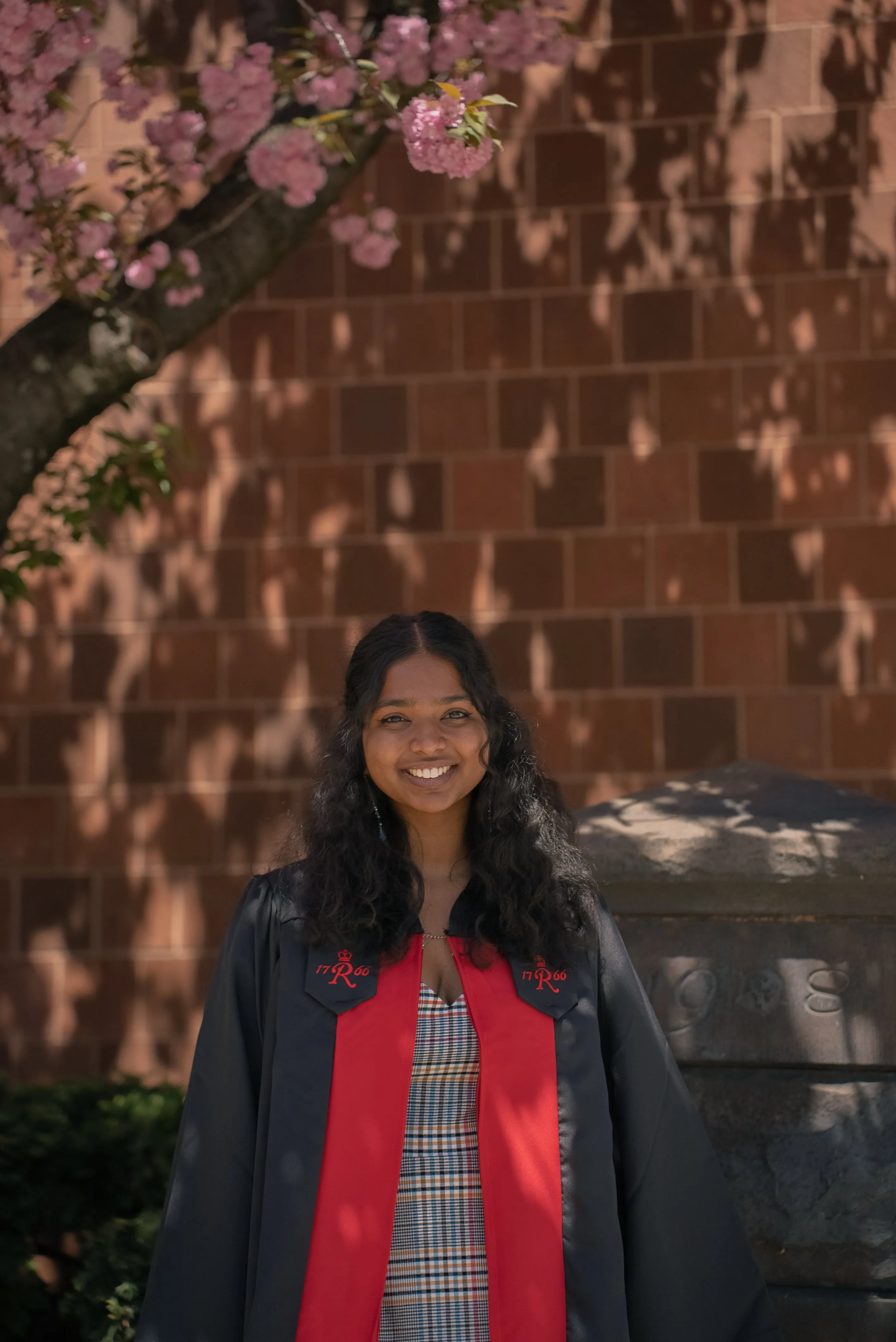 Sejal celebrating beneath a flowering tree