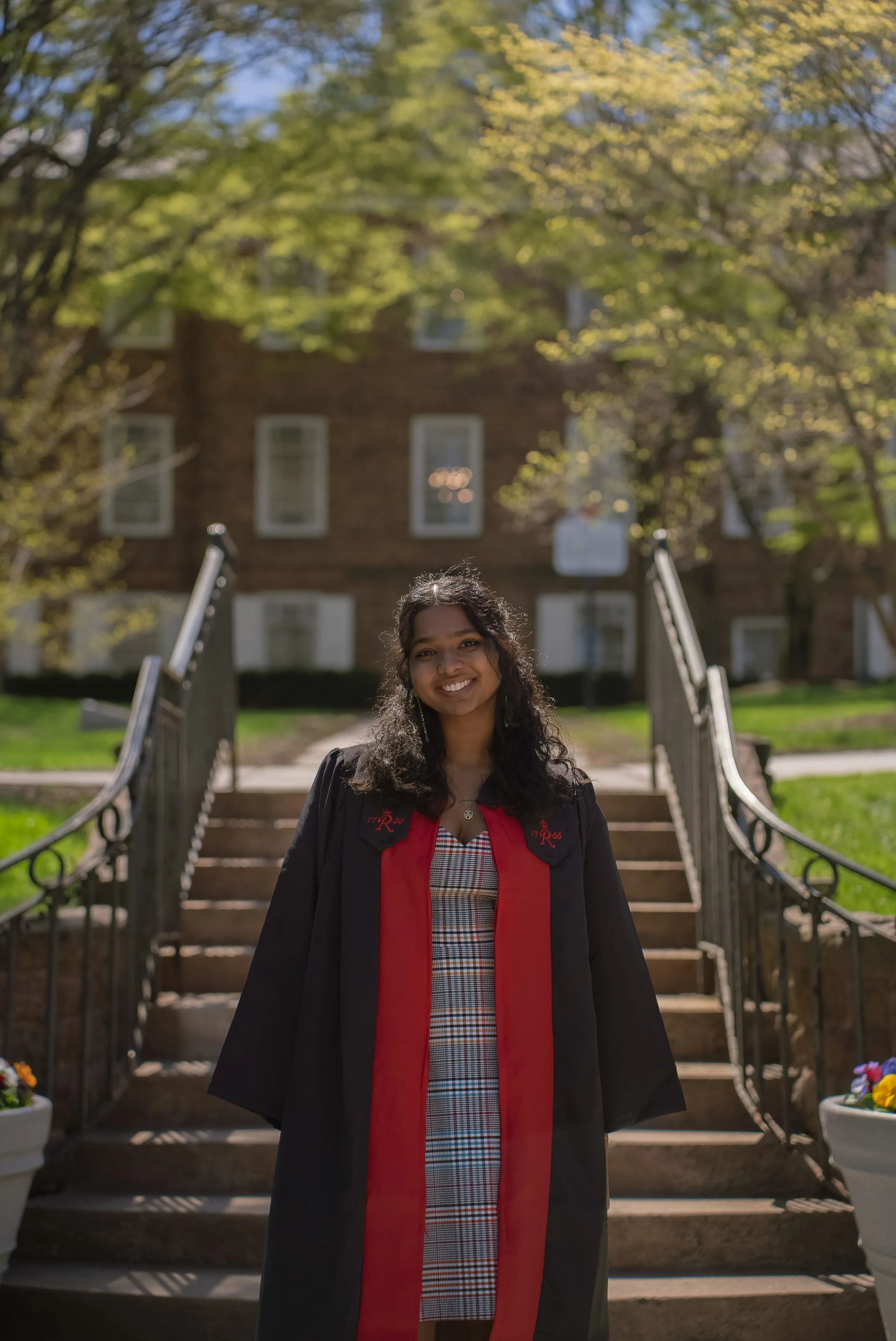 Sejal smiling in graduation regalia