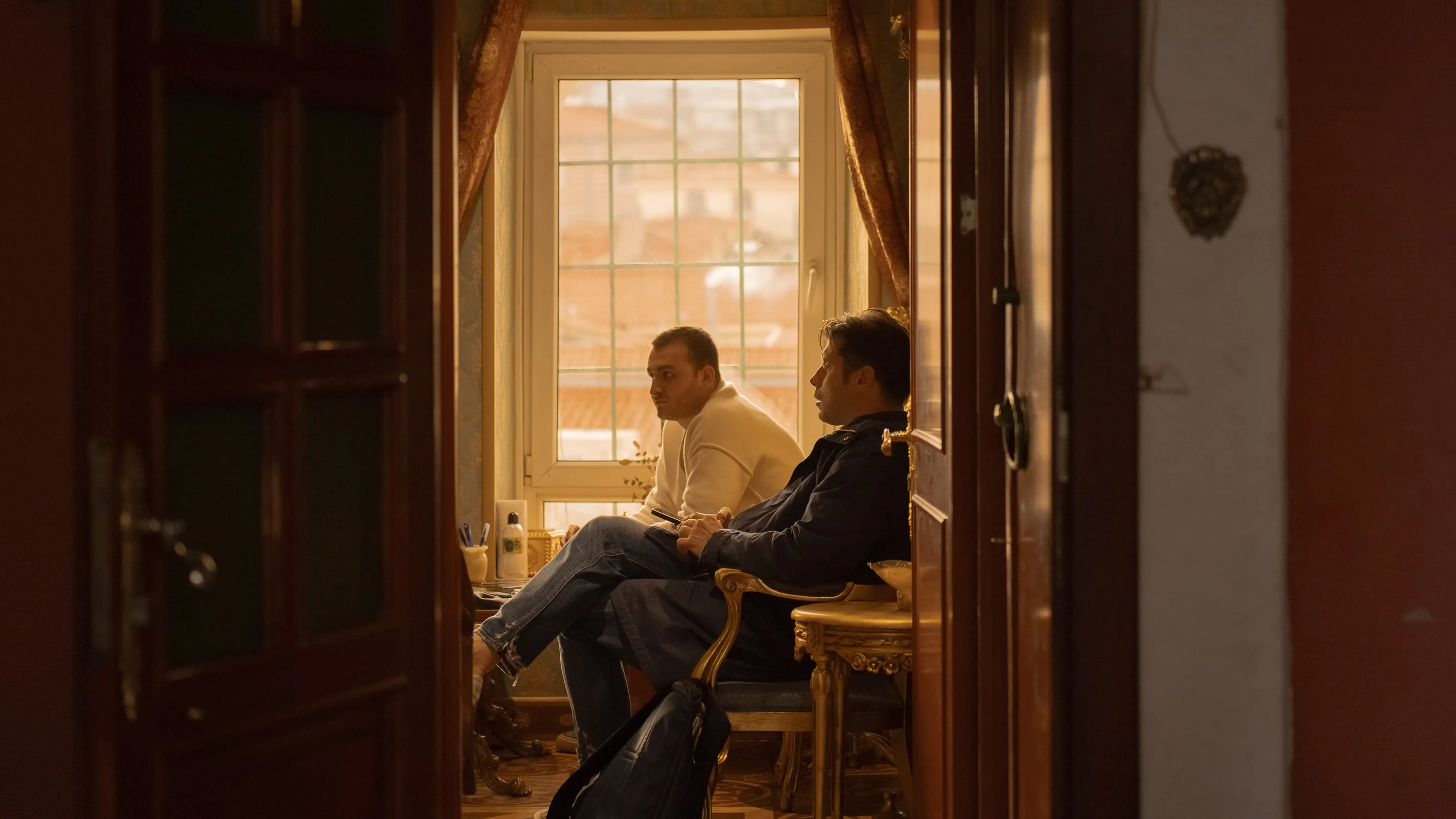 two men in a sunny room